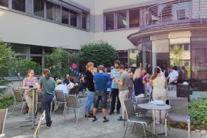 Women and men talking in the courtyard