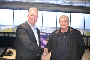 Brian Bruckbauer, Frequentis Defense and Norbert Violette, Airfield Operations Manager, U.S. Army Garrison Katterbach, shaking hands