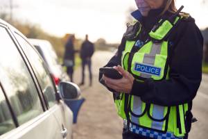 female police officer with mobile phone in hand