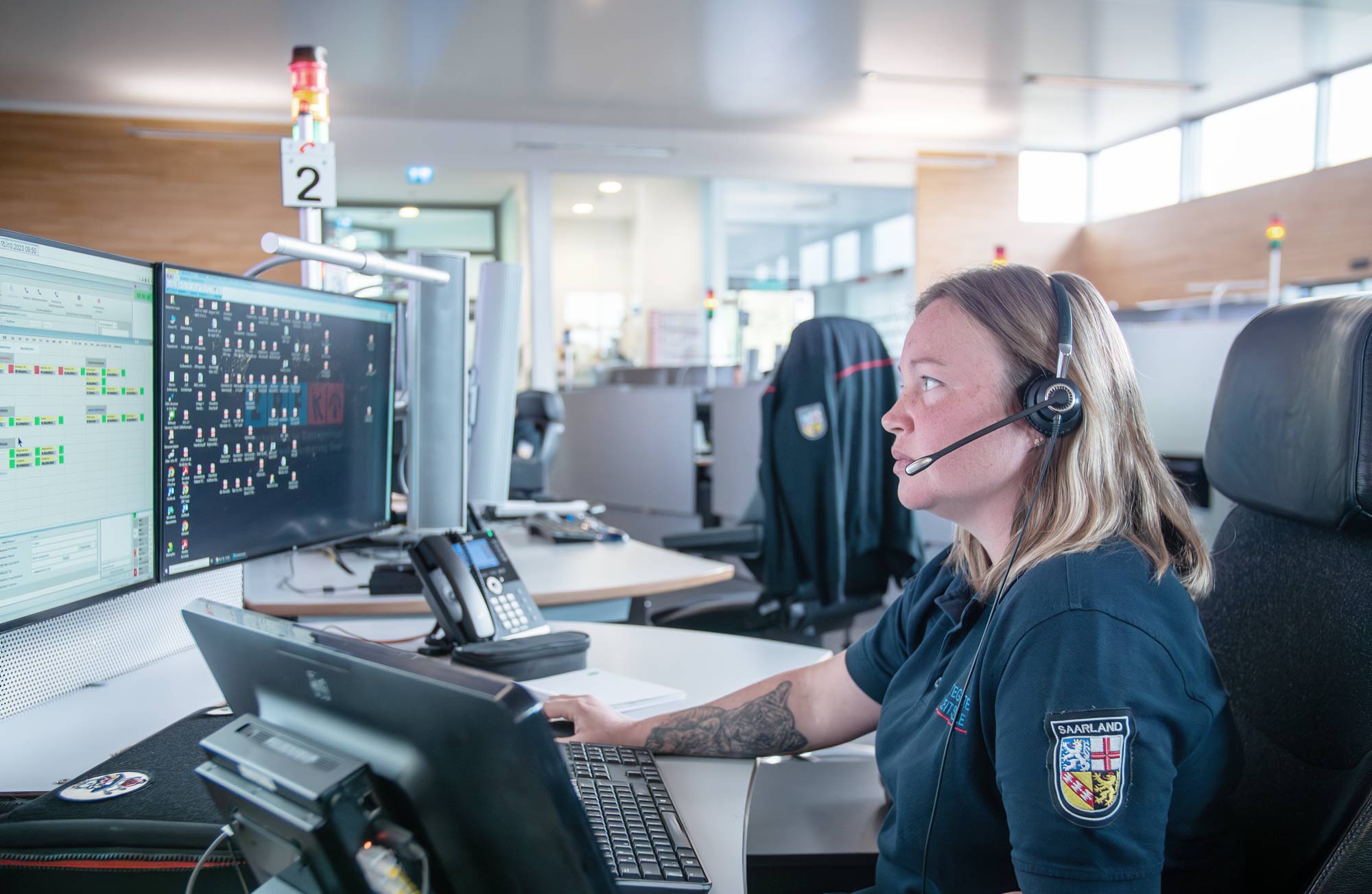 ASGARD header picture, showing a control room, screens, a woman operating