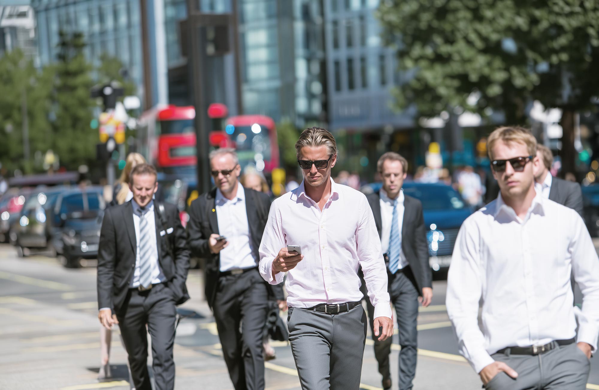 picture showing a group of business men on the streets, mobile devices in their hands