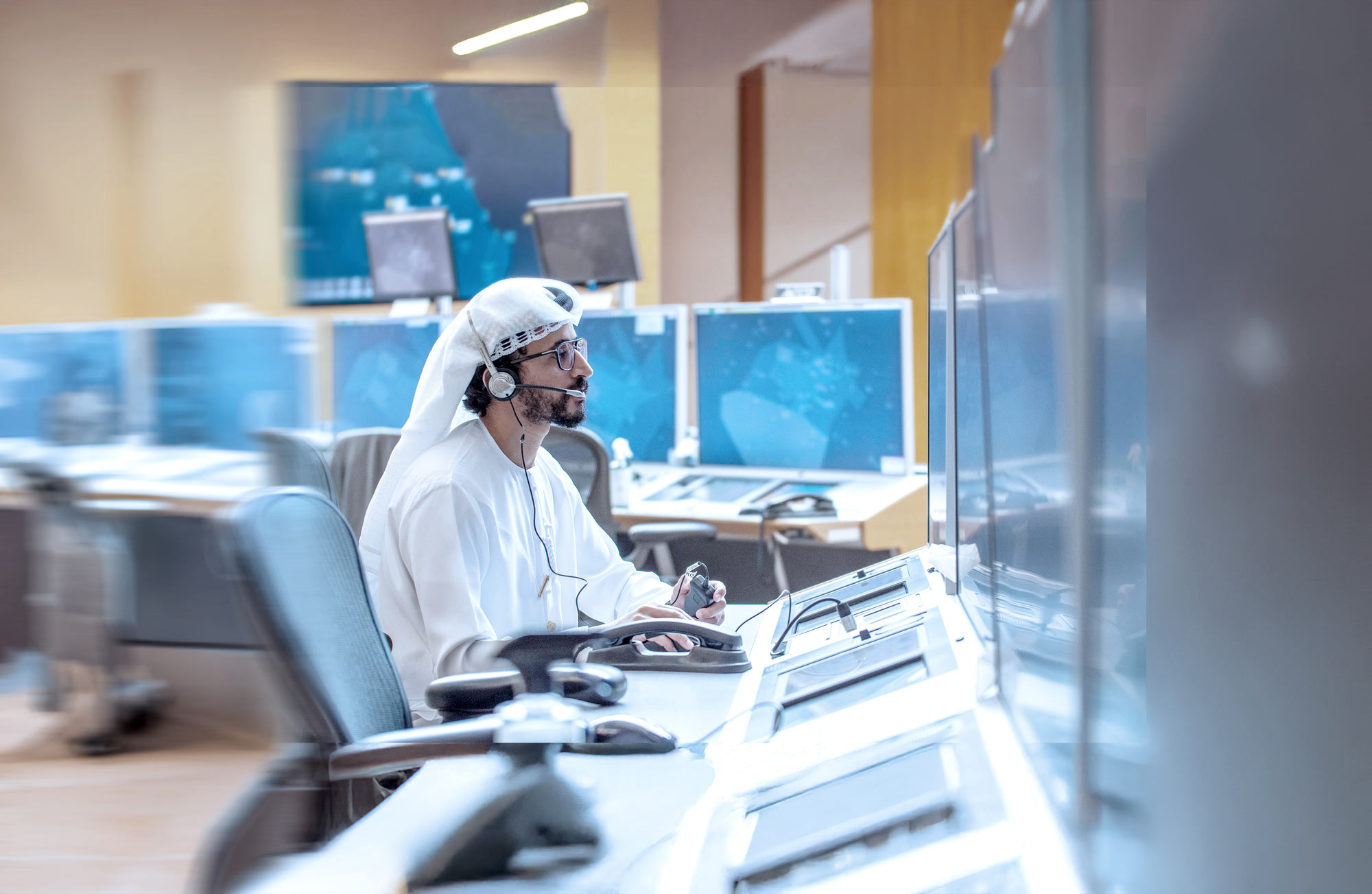 Frequentis OneATM focus area on harmonised control centres, showing a person operating in a control centre
