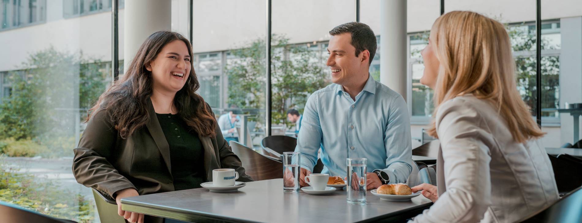 two women and a man enjoying their coffee break