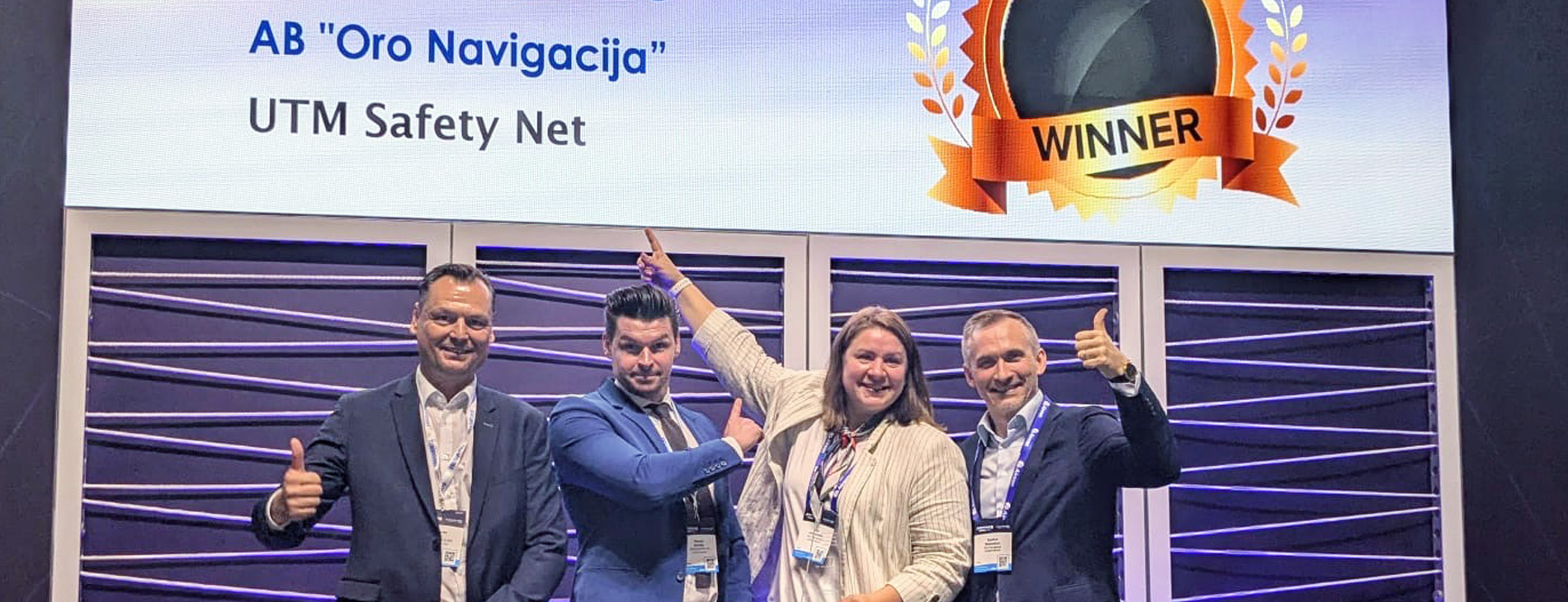 FREQUENTIS and Oro Navigacija win ATM Award for Innovation to Enable Sustainable Future Skies, picture showing the team at the stage at Airspace World in Lisbon