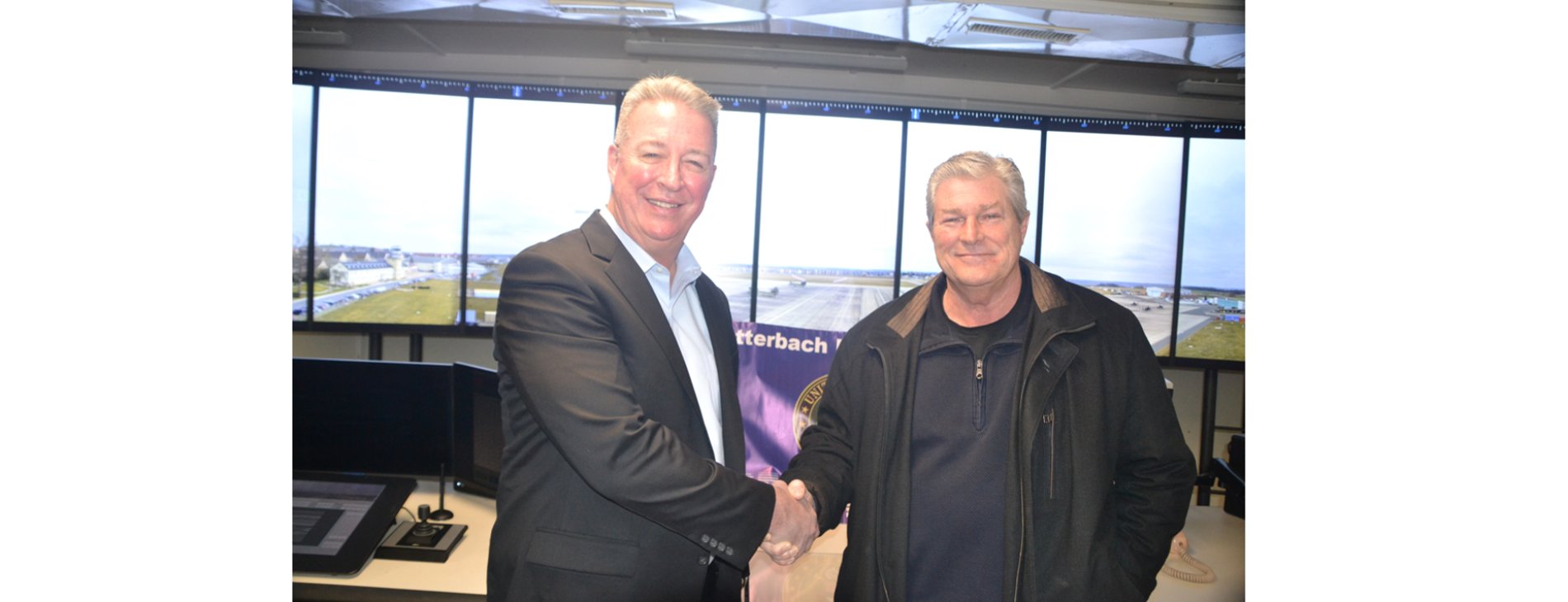 Brian Bruckbauer, Frequentis Defense and Norbert Violette, Airfield Operations Manager, U.S. Army Garrison Katterbach, shaking hands
