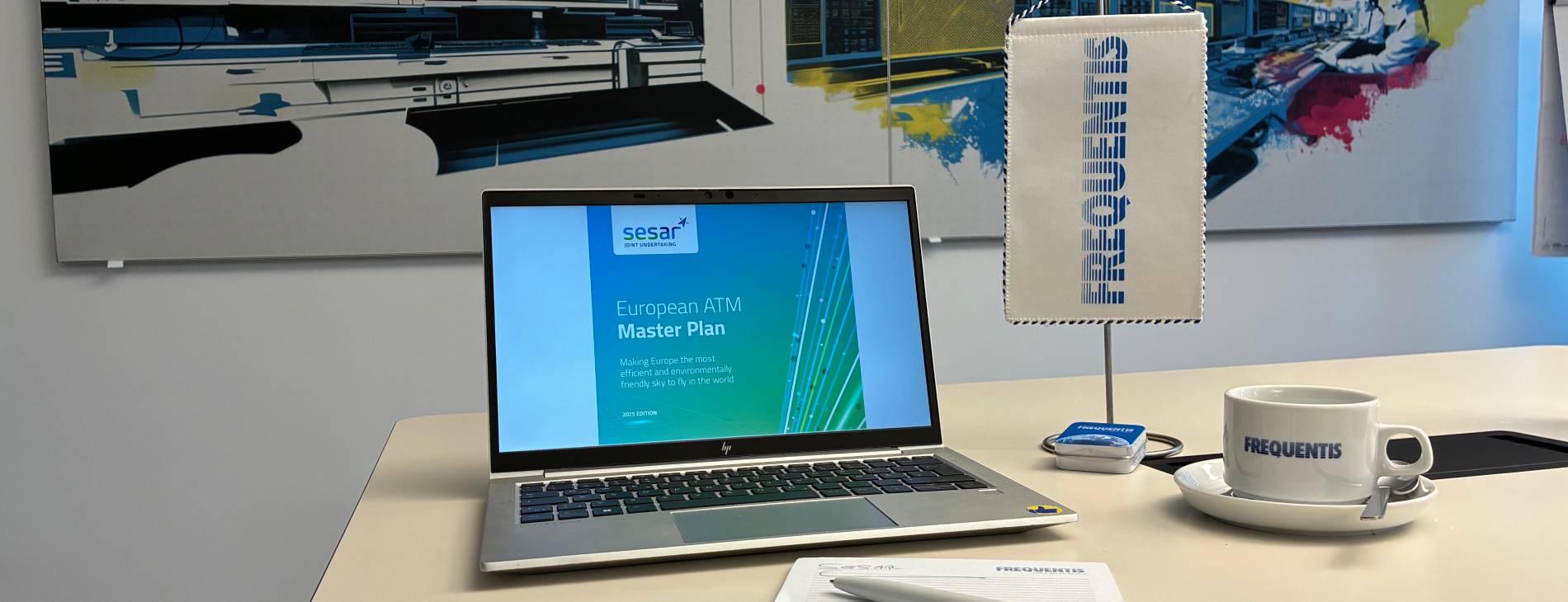 Desk with: Computer showing SESAR European ATM Master Plan, Coffee mug, notepad, pen