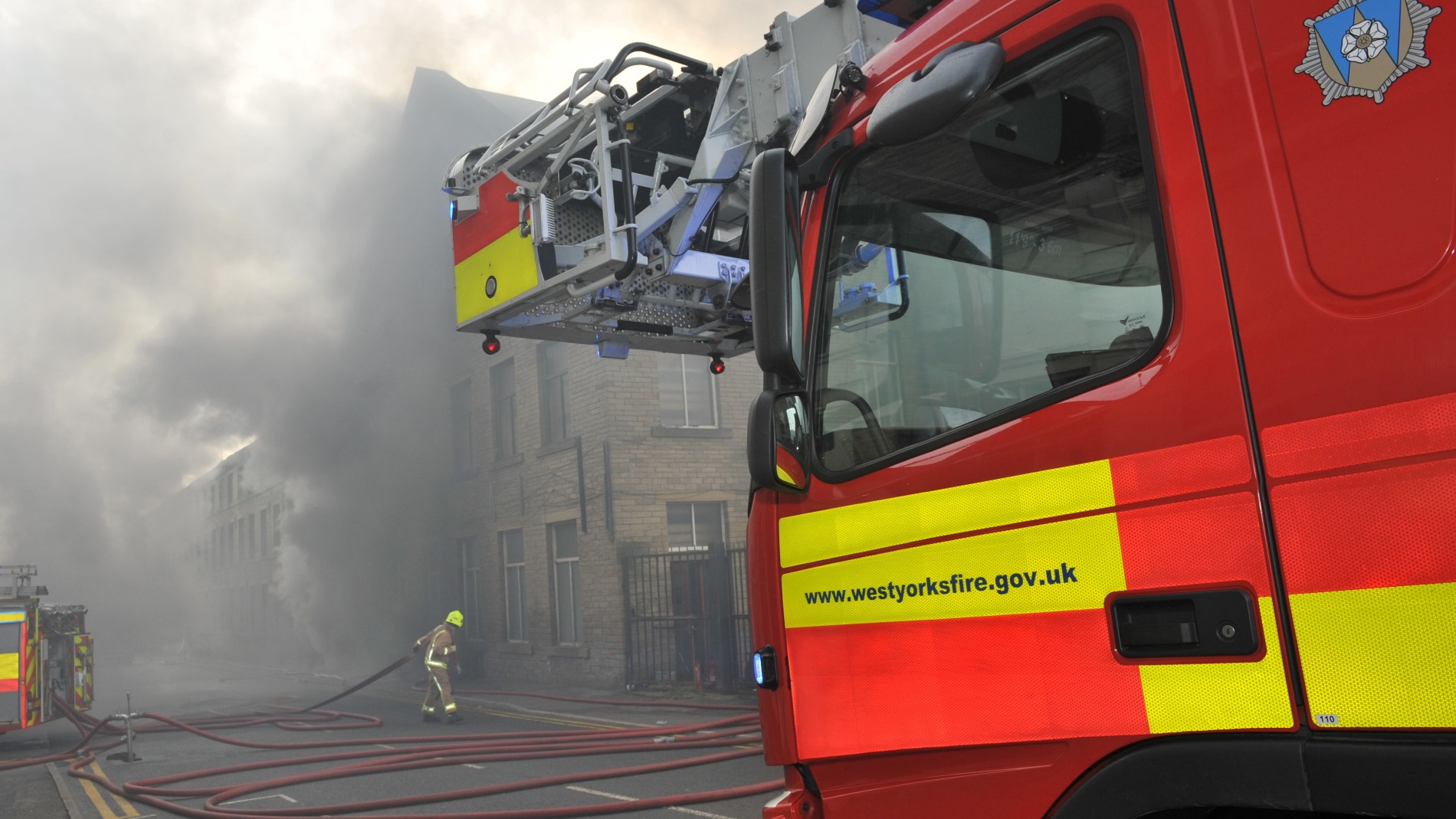 ein Feuerwehrauto vor einem brennenden Haus